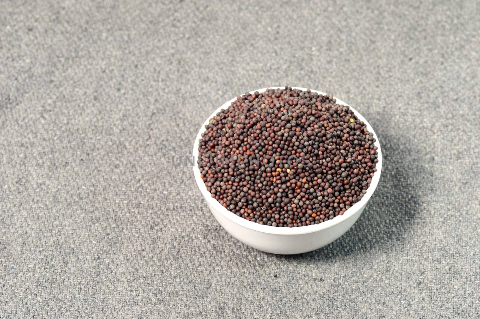 Brown Mustard Seeds in bowl on sackcloth