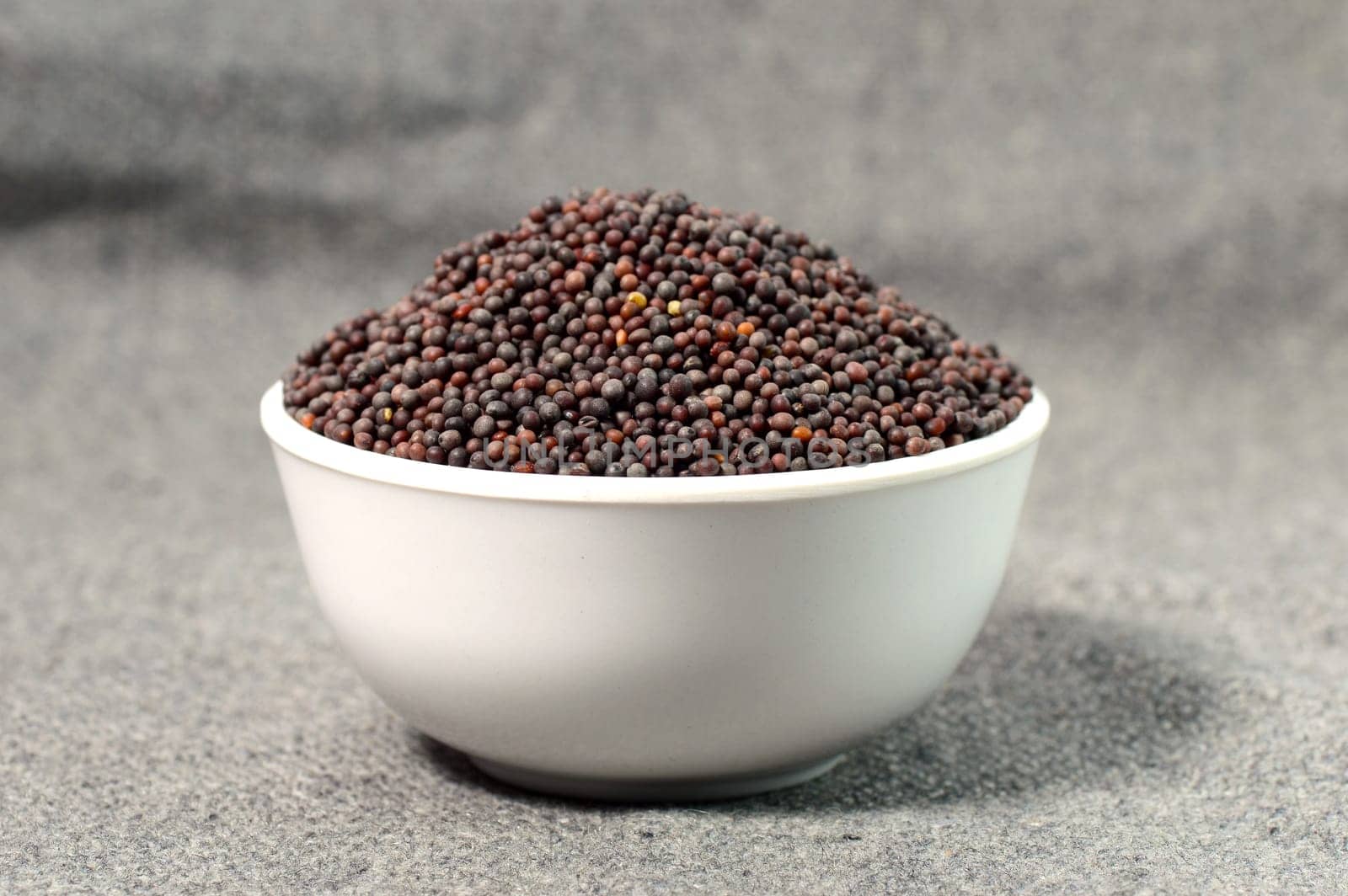Brown Mustard Seeds in bowl on sackcloth