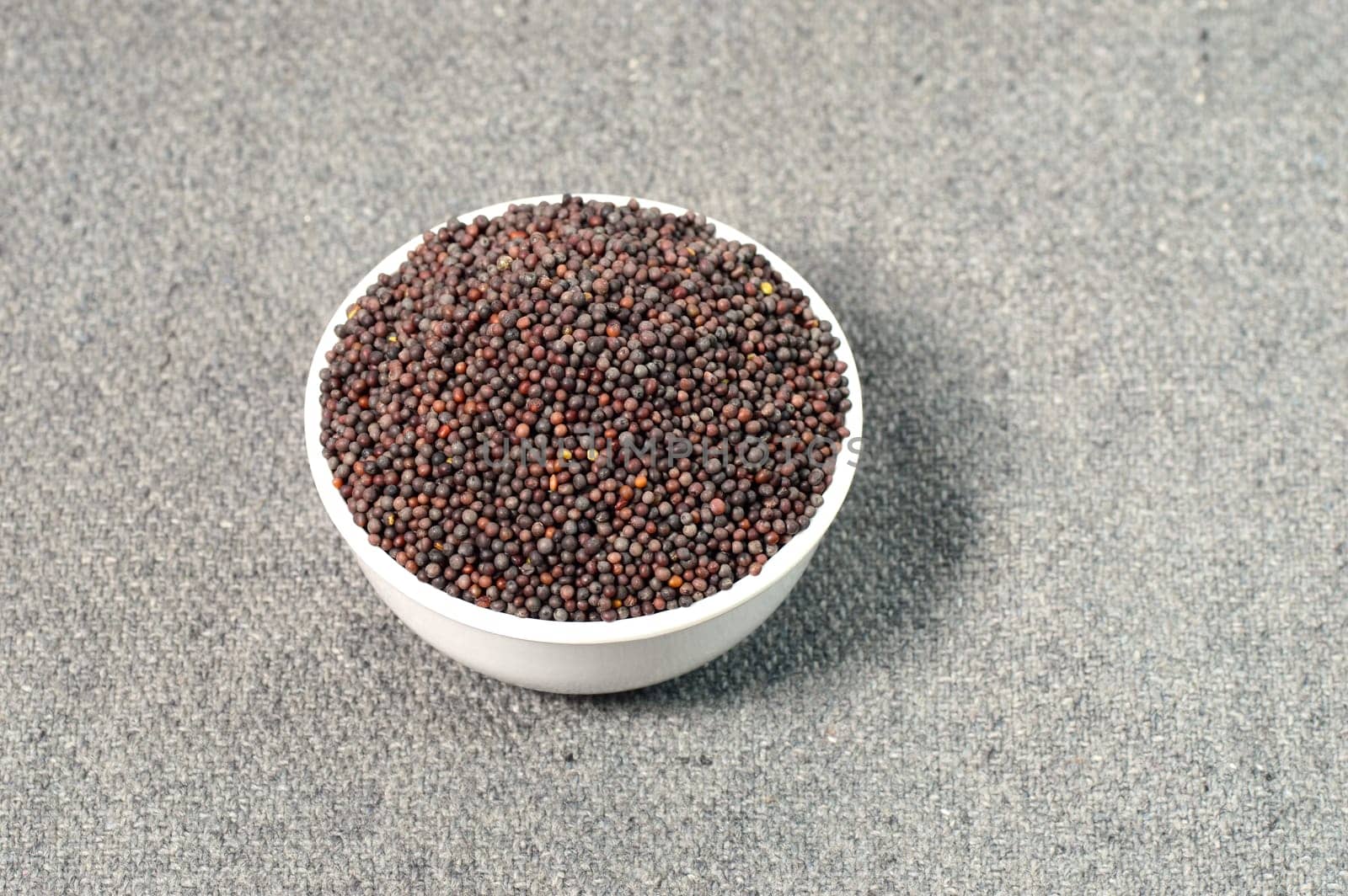 Brown Mustard Seeds in bowl on sackcloth