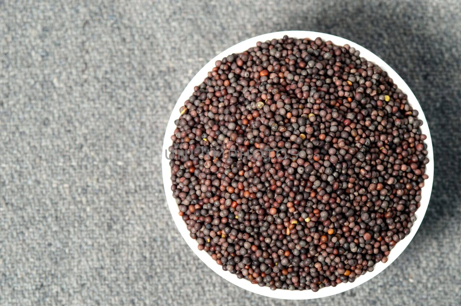 Brown Mustard Seeds in bowl on sackcloth
