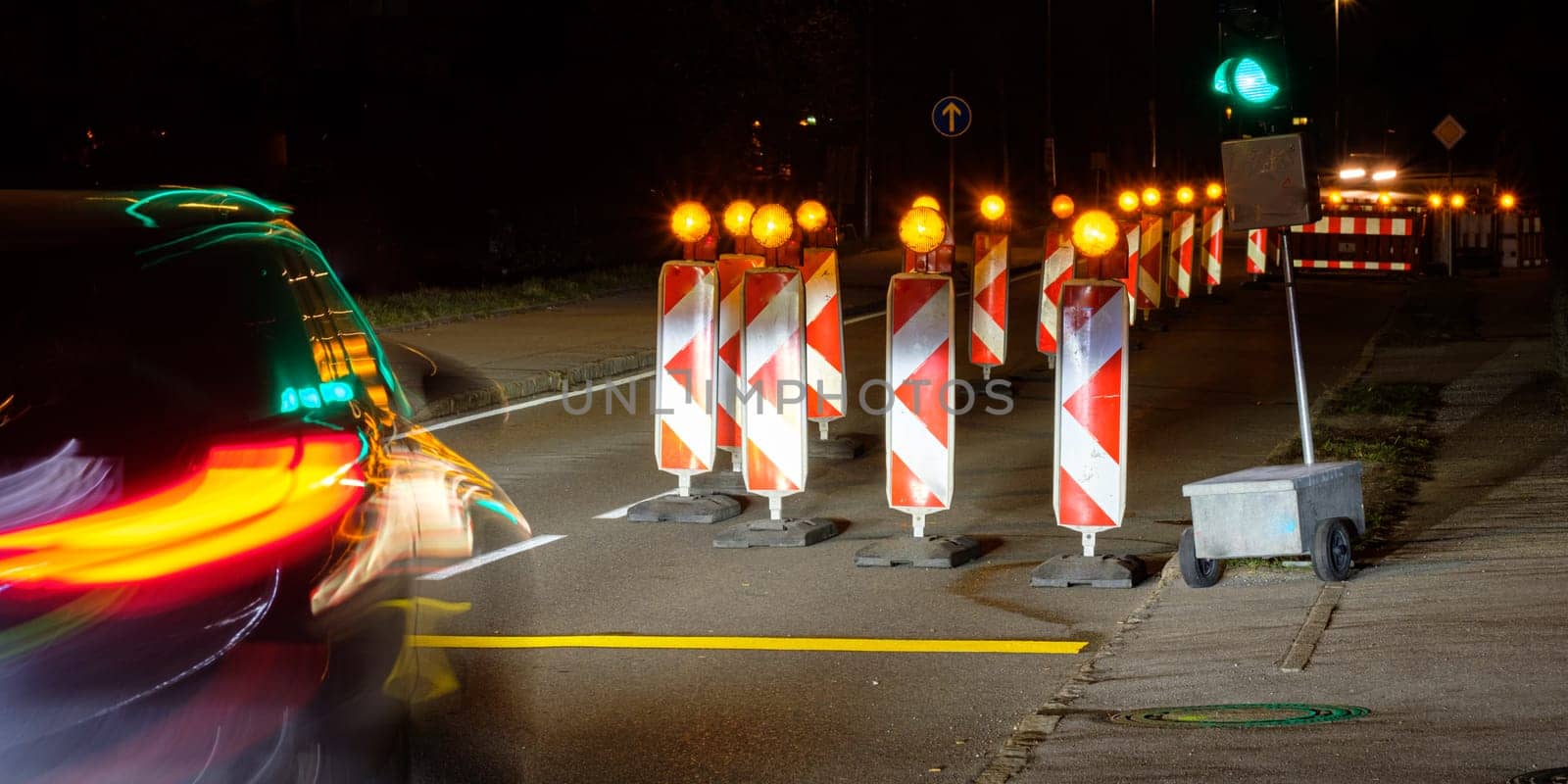 Car with light reflection of a traffic light are driving