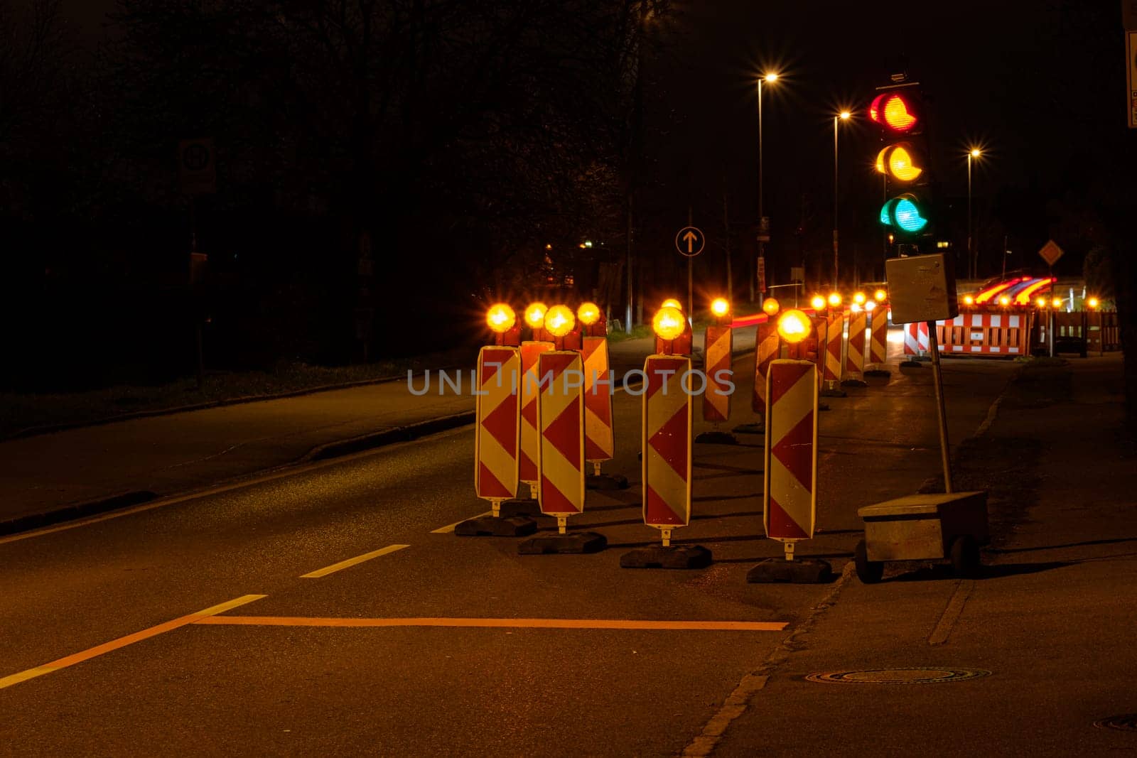 Traffic light at a construction site in night.