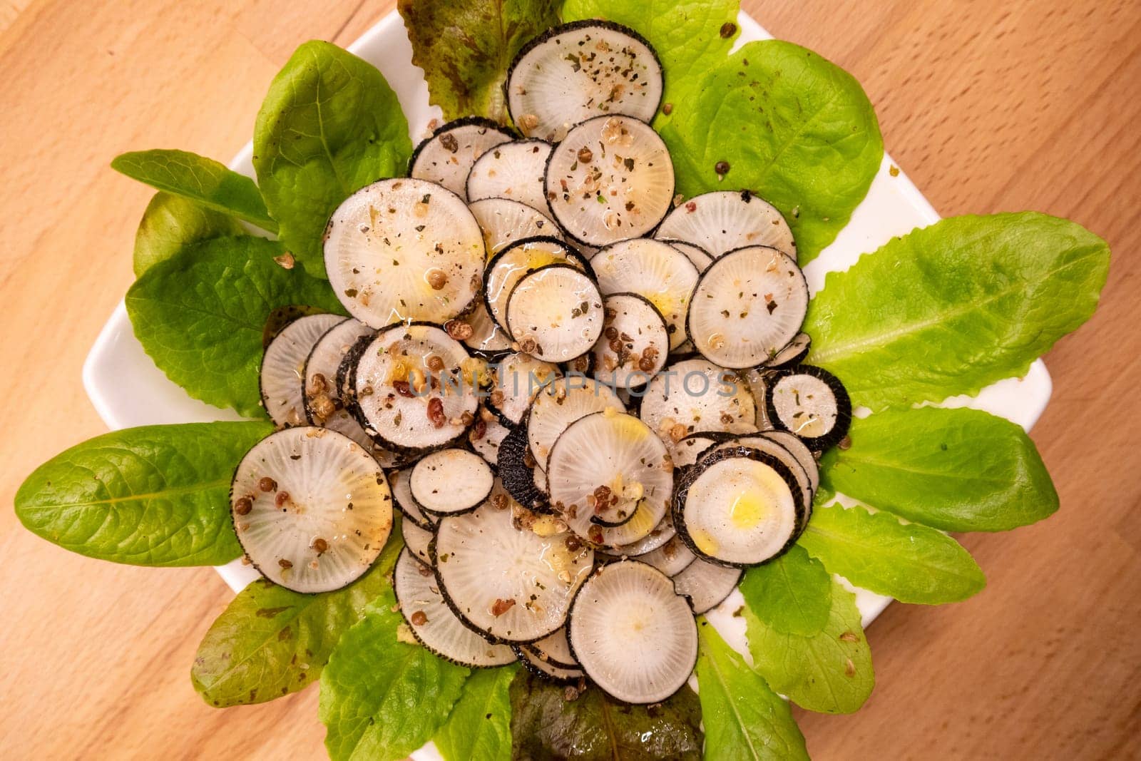 Black radish salad with spices in a plate