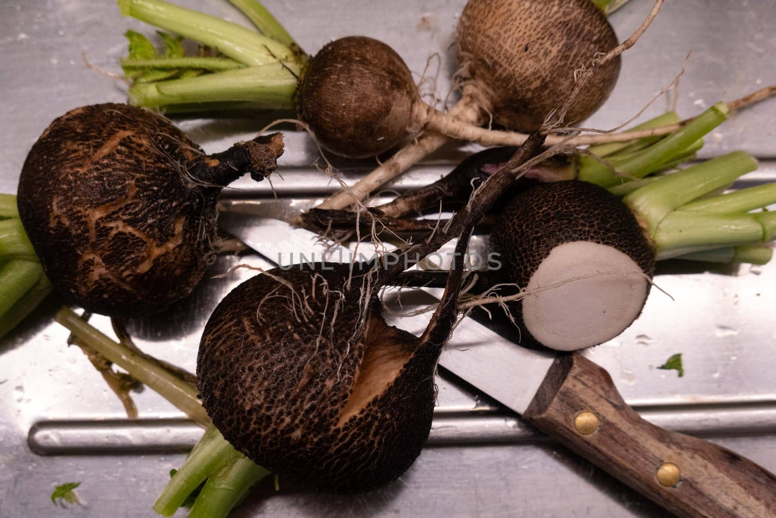 Preparing black radish for salad in the kitchen