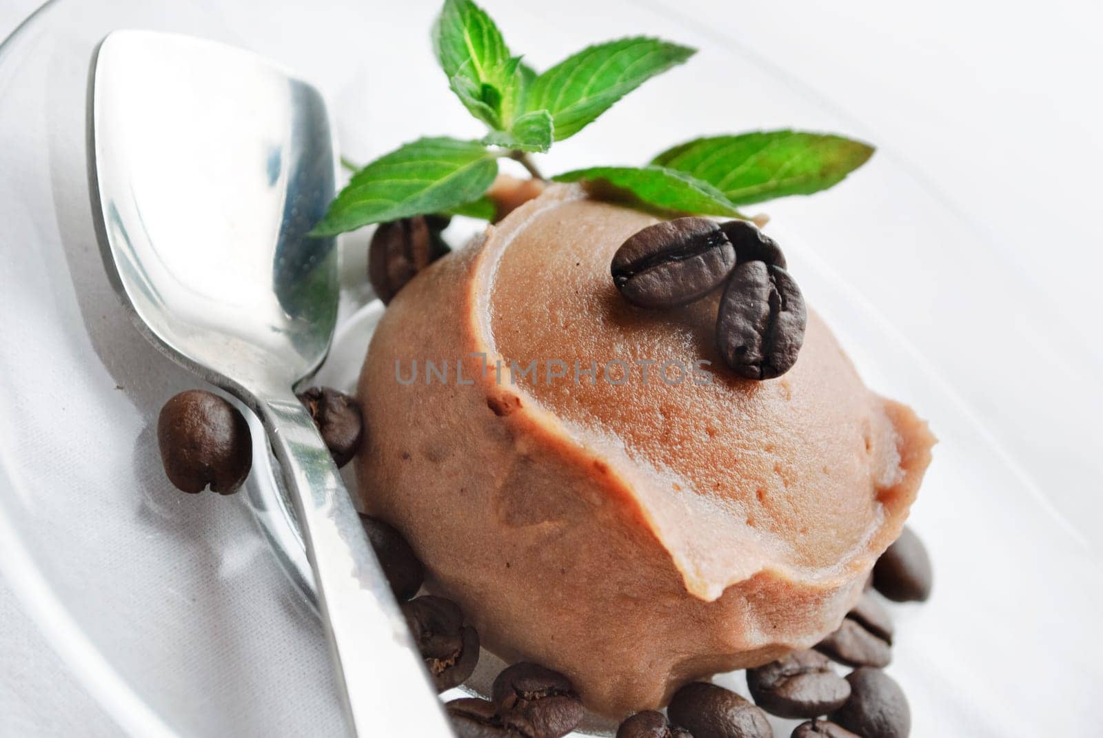 Ice cream decorated with fresh mint and coffee beans