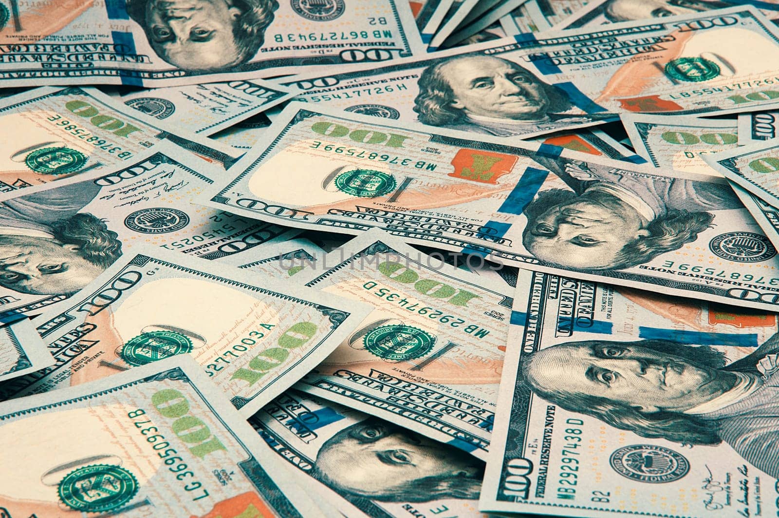 Cash hundred dollar bills, dollar background image. Scattered dollars. A big pile of dollars. Background of North American dollar bills. Color style. Top view for collage and presentation editing.