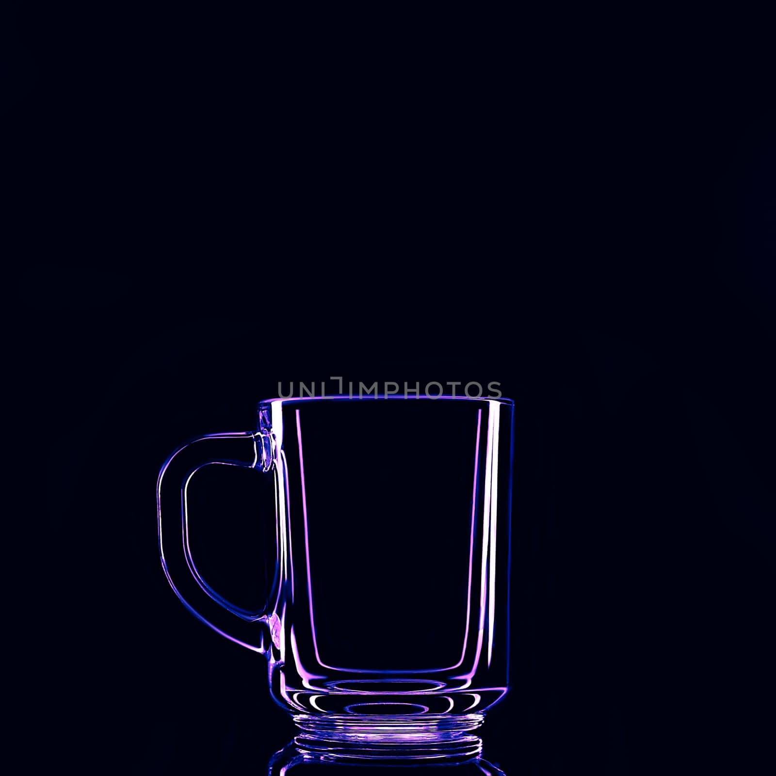 Just a glass on a black background with a reflection. Purple colors. Isolated.