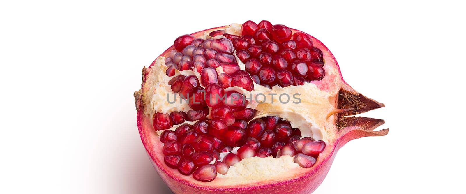 Garnet isolated part on a white background close-up with shadow. Fresh pomegranate. Juicy pomegranate. Delicious pomegranate. Place for advertising, logo, lettering, layout, mockup.