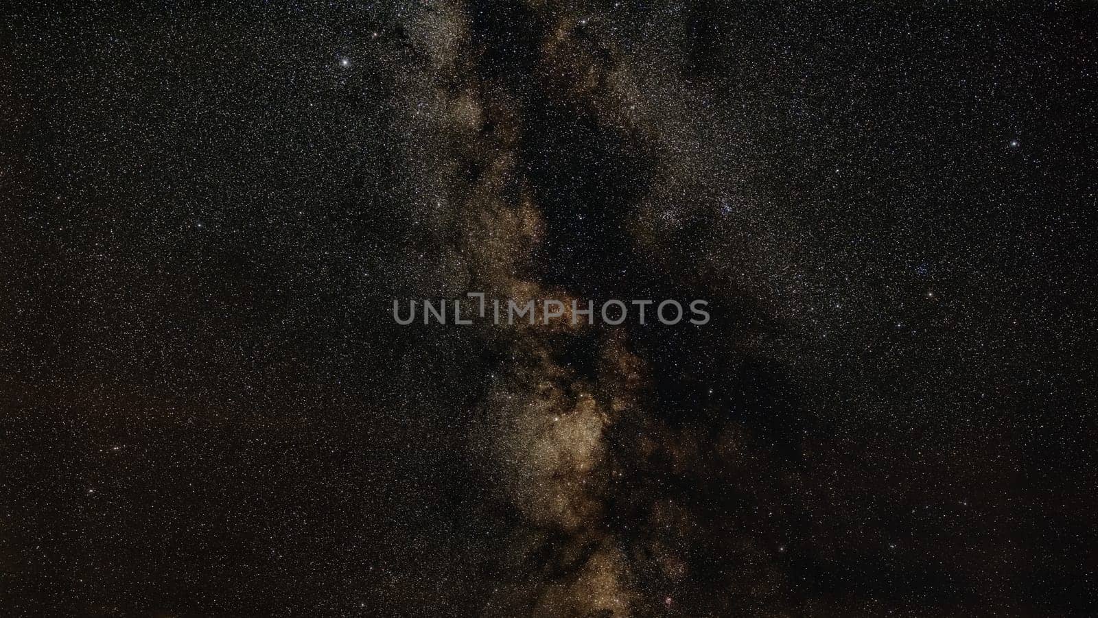 Night sky, many stars with milky way around Aquila and Scutum constellation visible. Long exposure stacked photo.