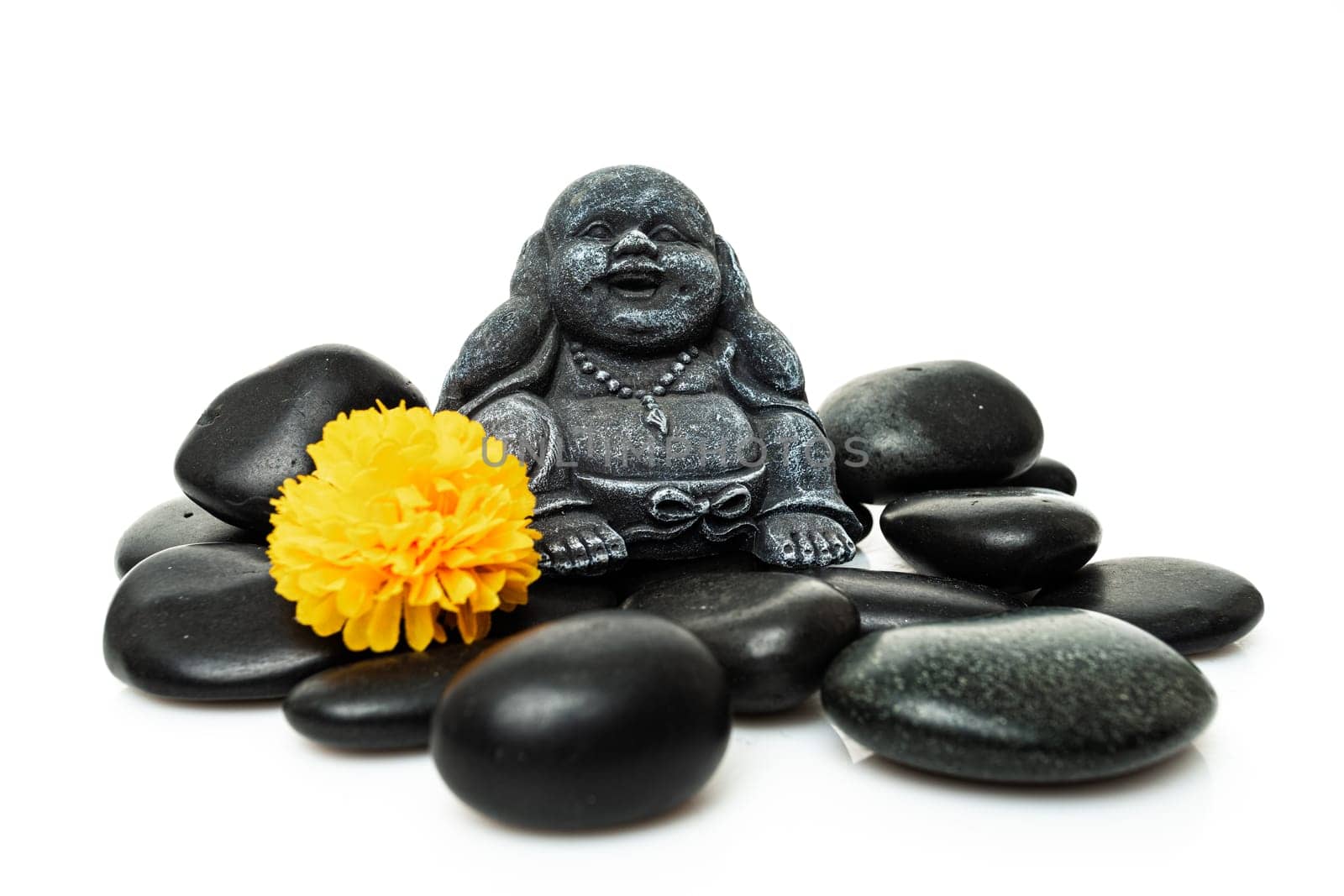 Buddha and stack of black basalt stones