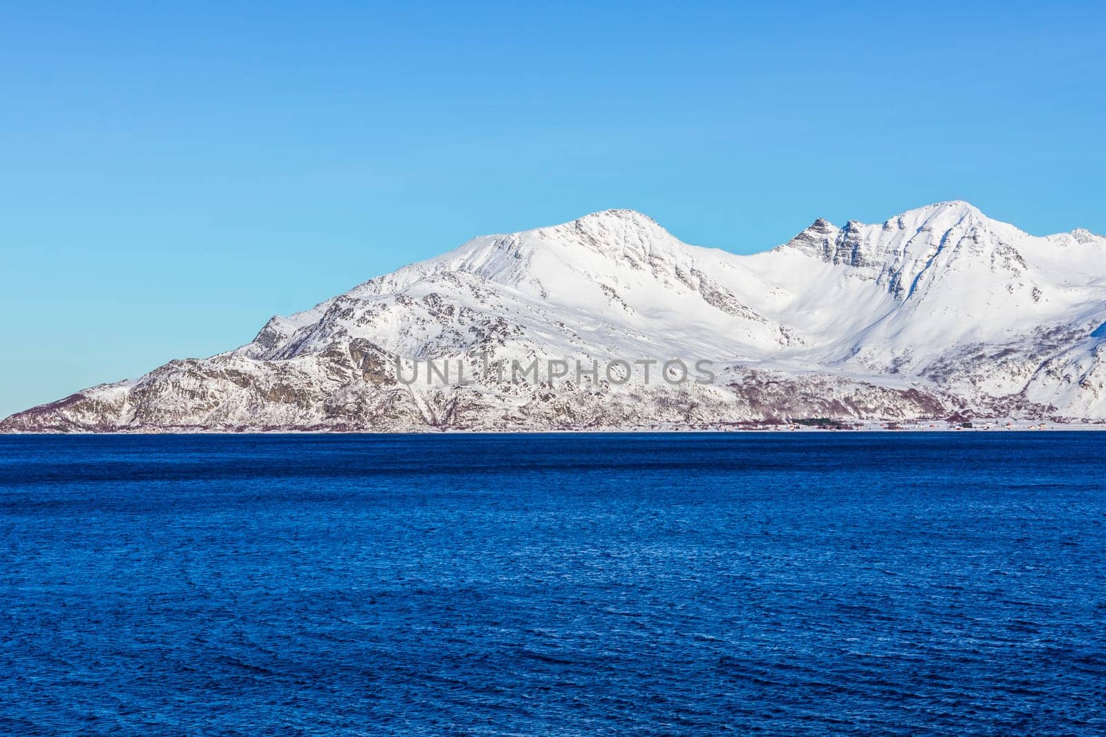 Snow mountain with ocean in norway
