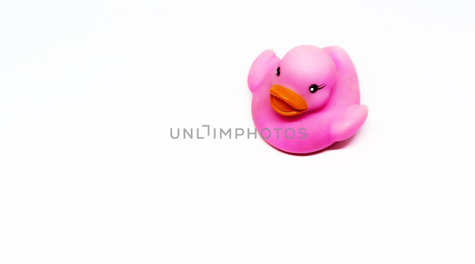 Pink rubber duck with orange beak isolated on a white background. Baby bath and shower for children. Toys and fun for children