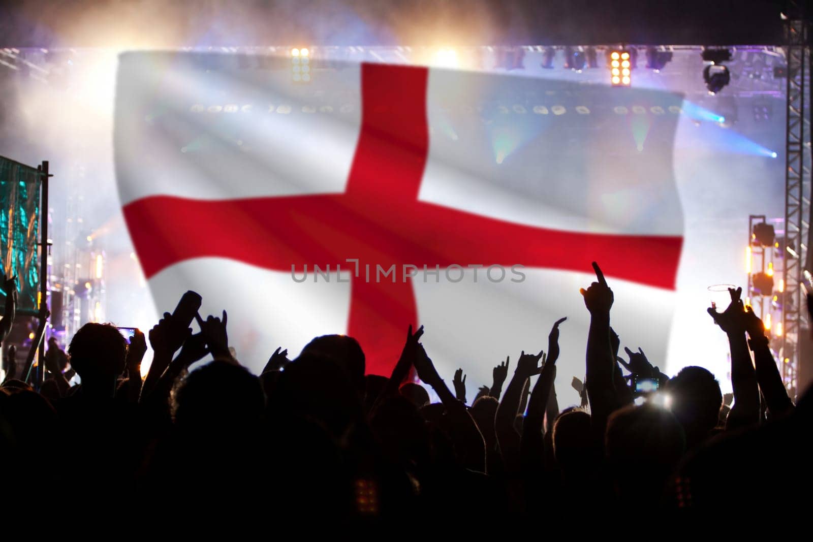 Soccer fans supporting England - crowd celebrating in stadium with raised hands against England flag