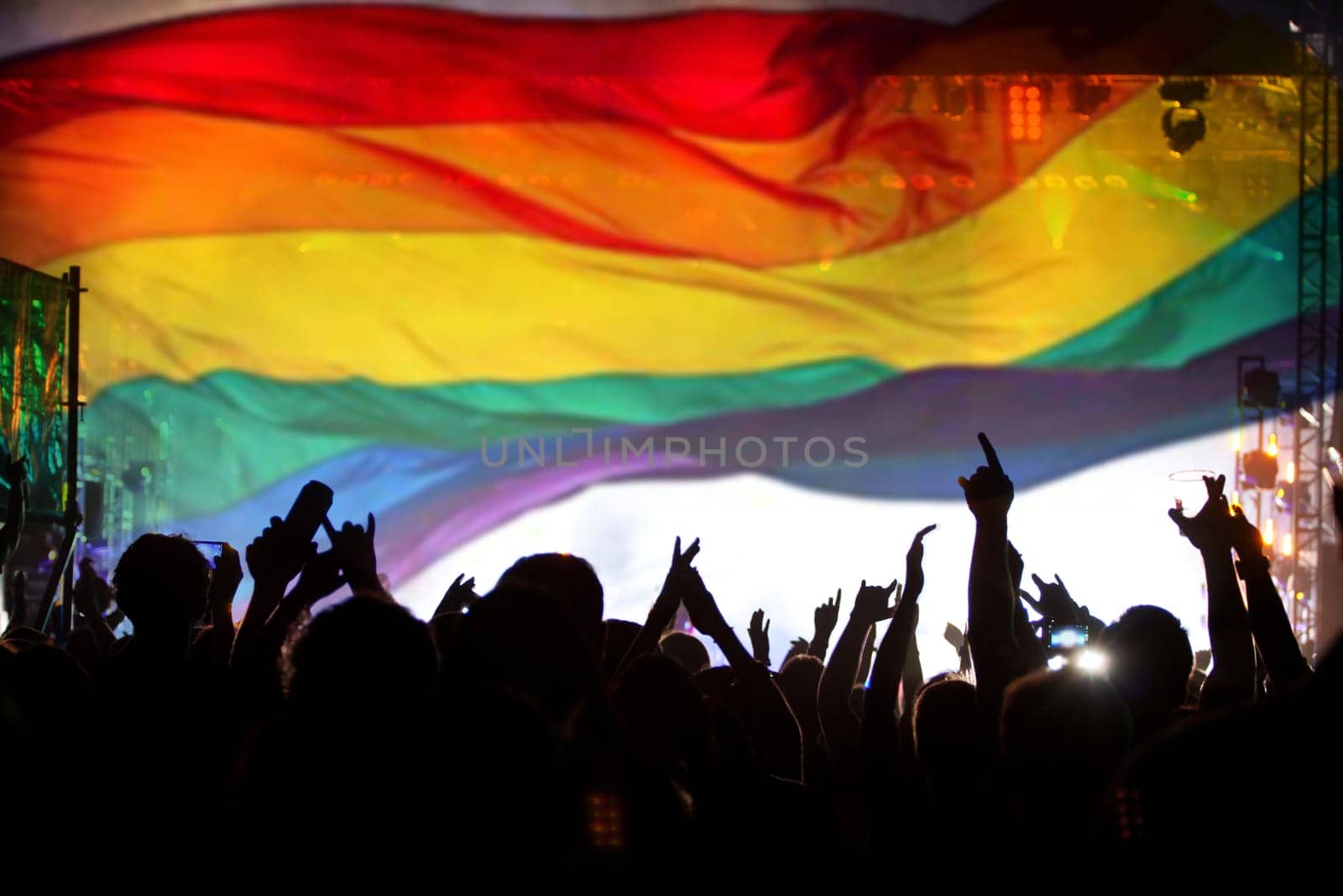Pride community at a parade with hands raised and the LGBT flag - symbol of love and tolerance