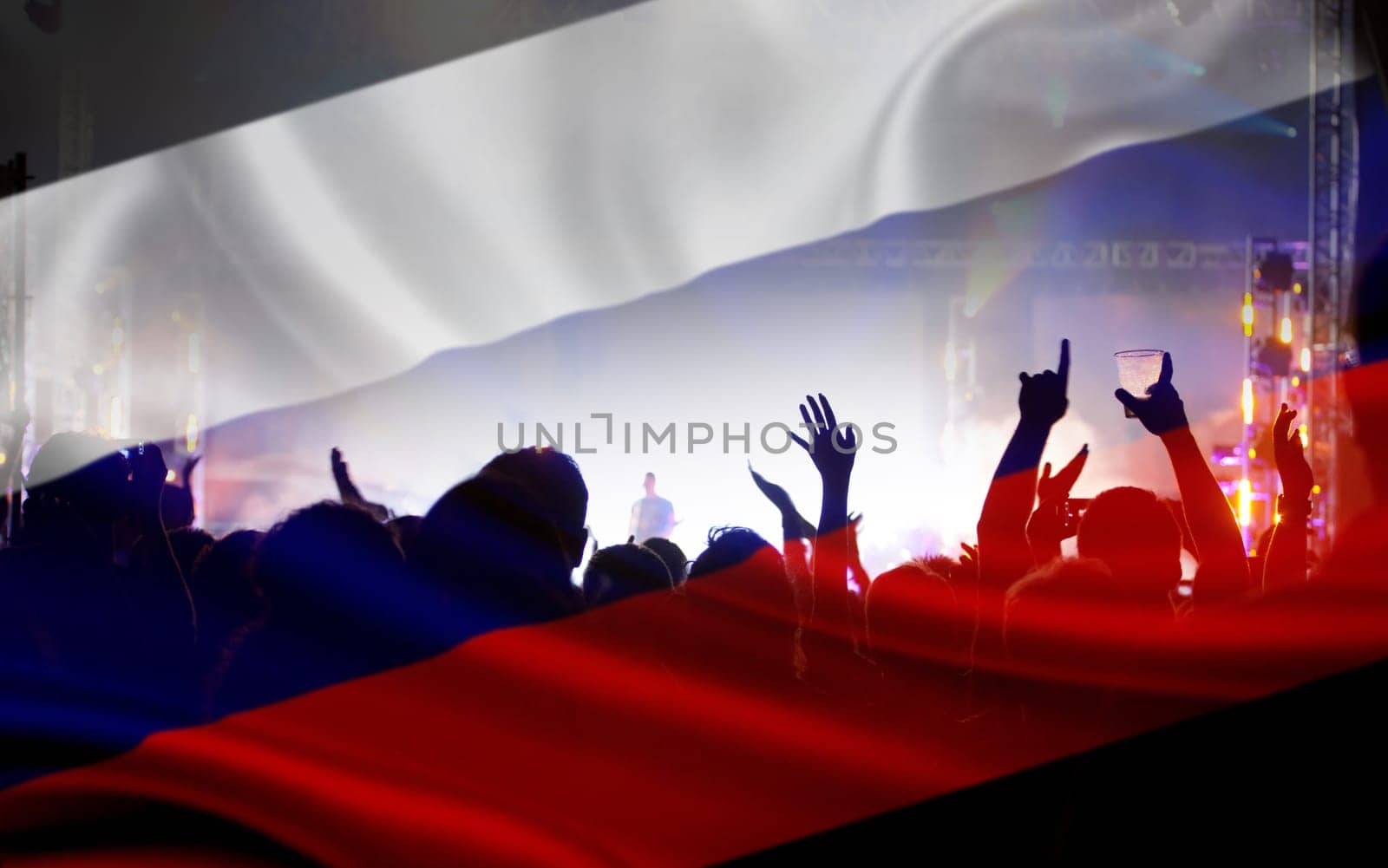 Soccer fans supporting Russia - crowd celebrating in stadium with raised hands against Russian flag