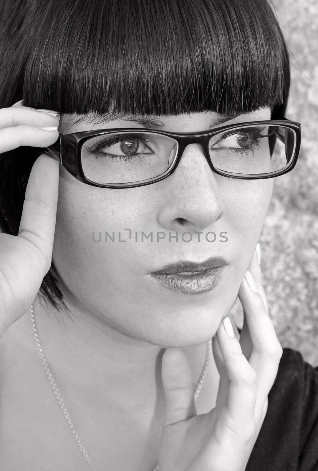 A young modern woman with glasses in black and white