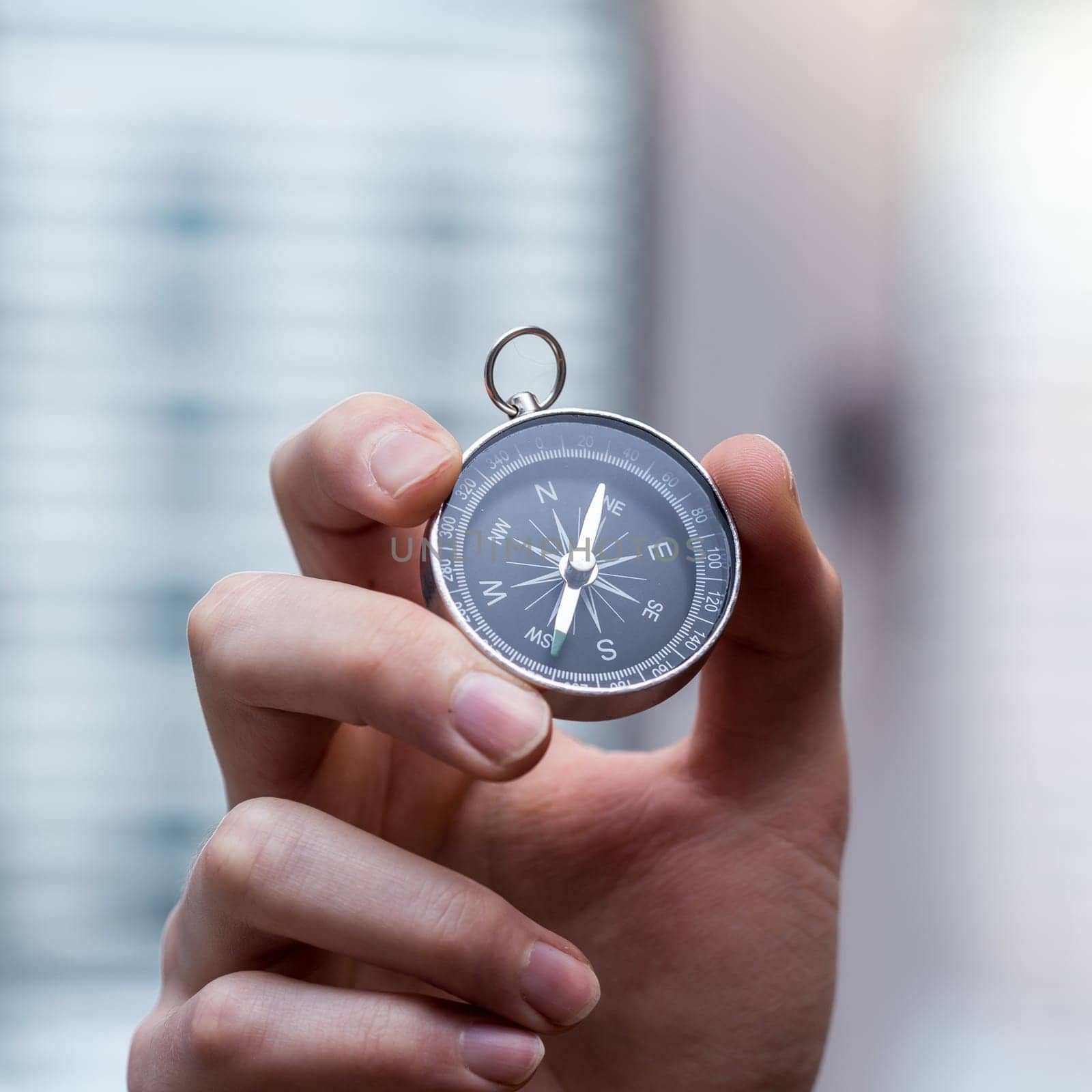Young freelancer with compass holding in hand, cutout