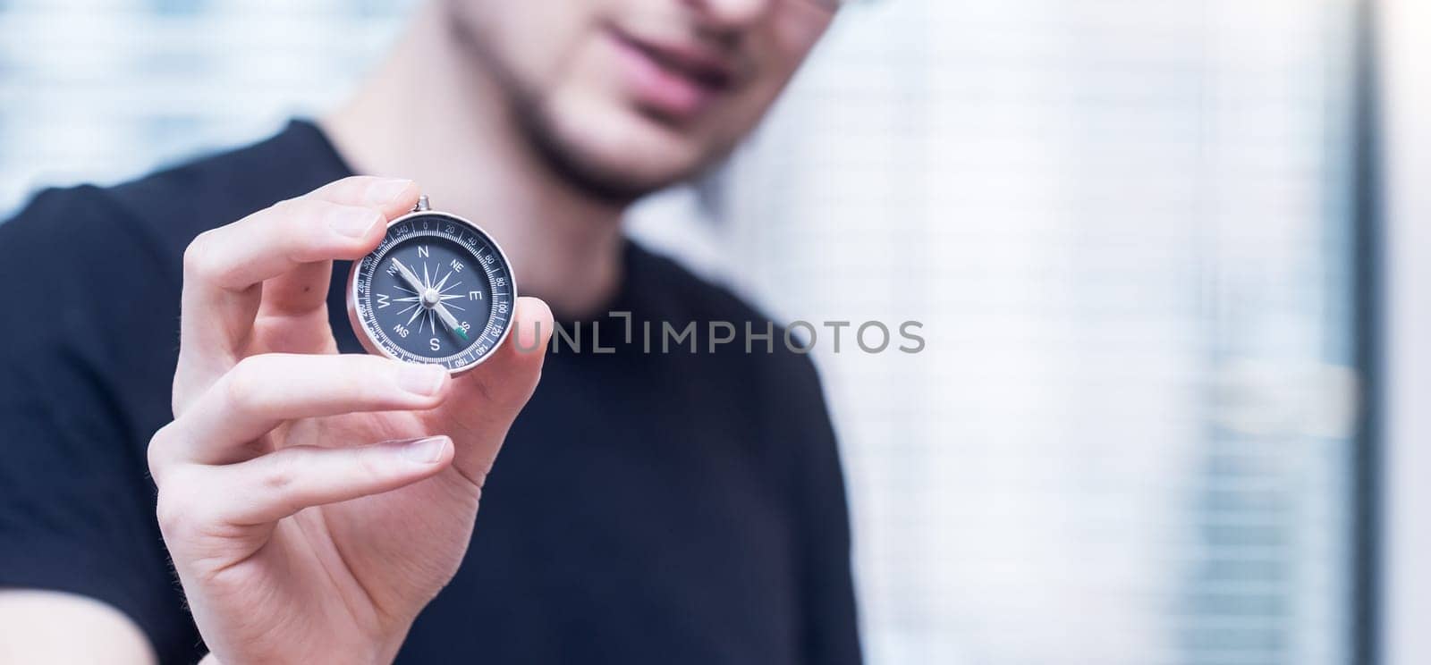 Young freelancer with compass holding in hand
