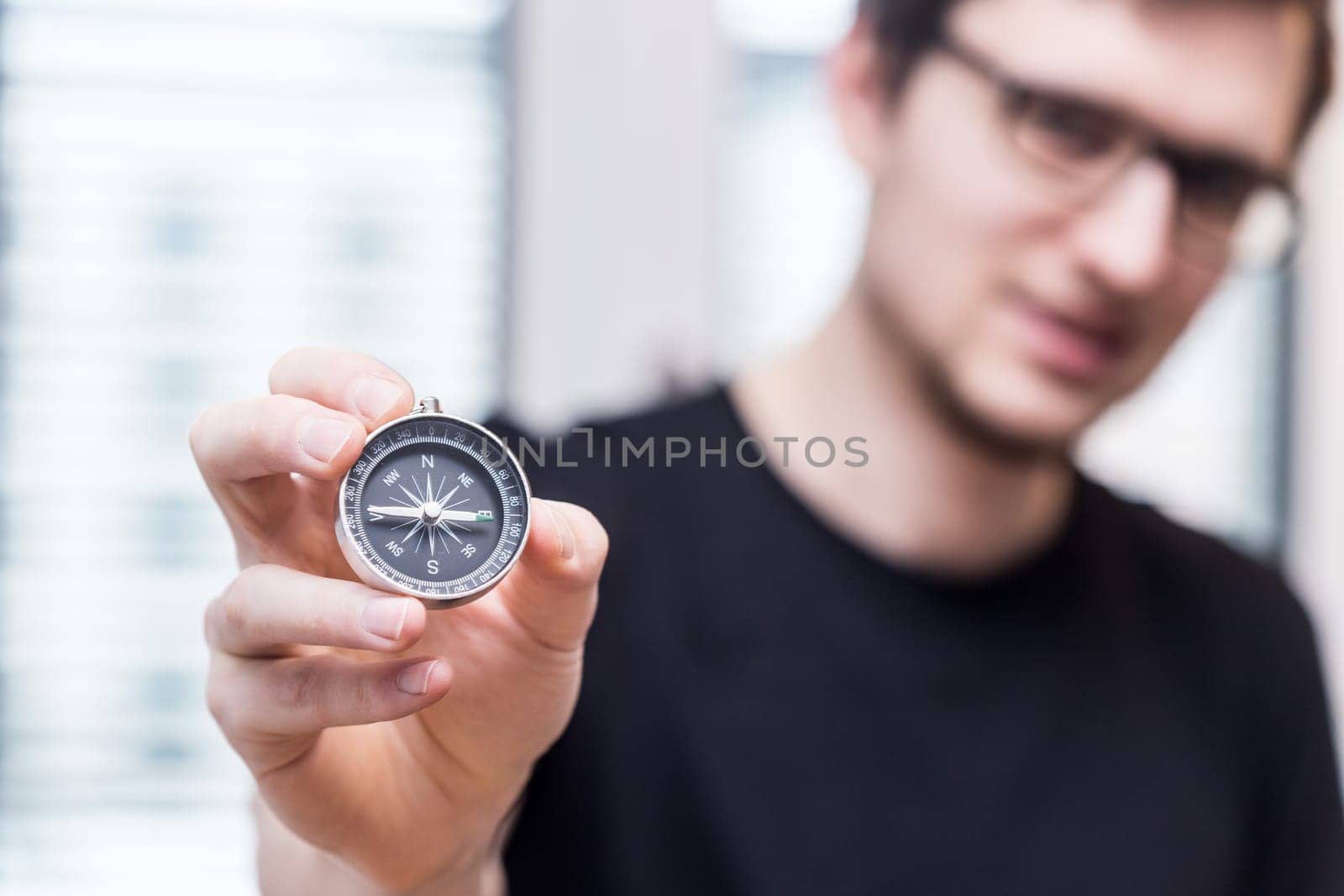 Young freelancer with compass holding in hand