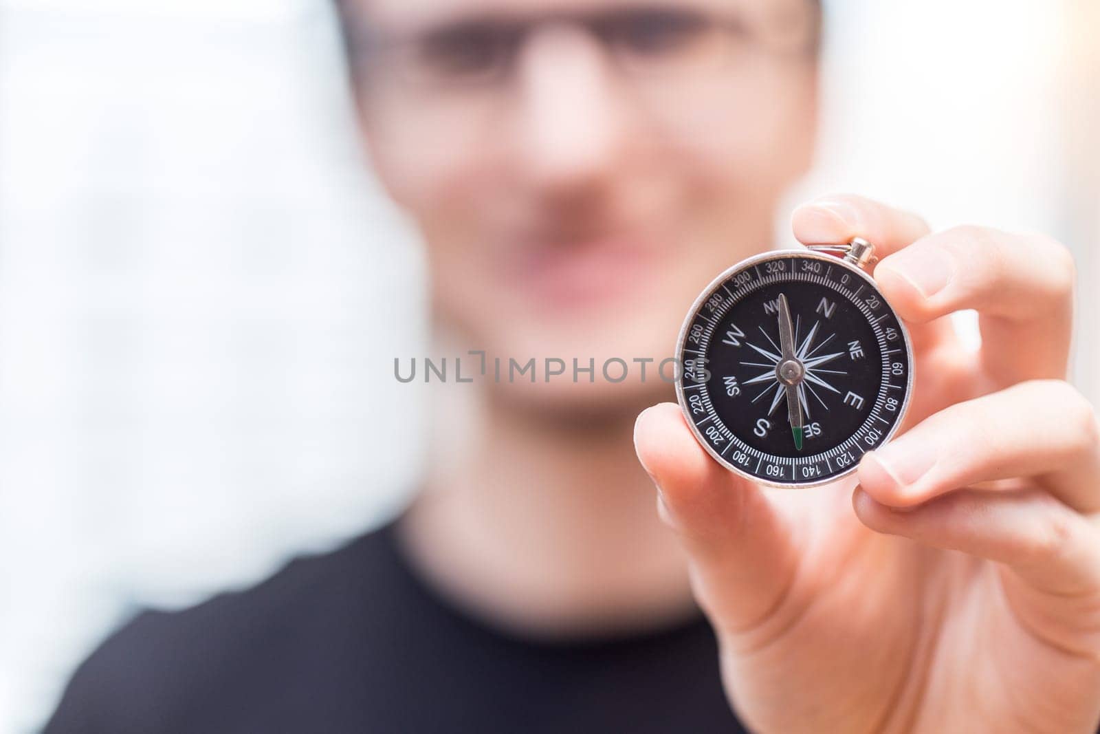 Young freelancer with compass holding in hand