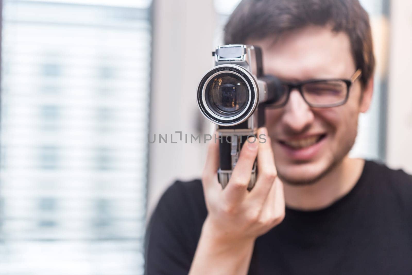 Filmmaker is doing a movie, vintage old movie camera