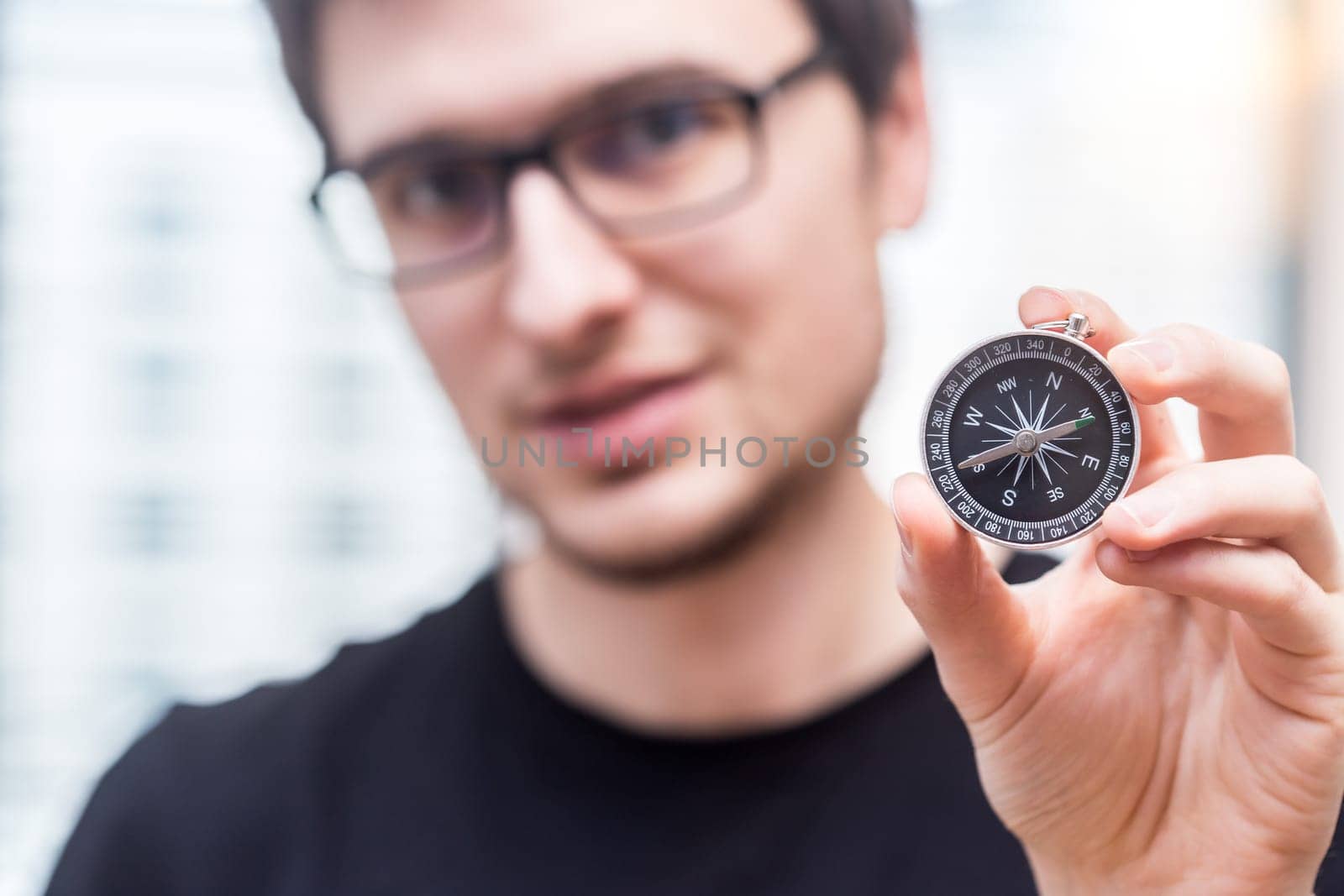 Young freelancer with compass holding in hand