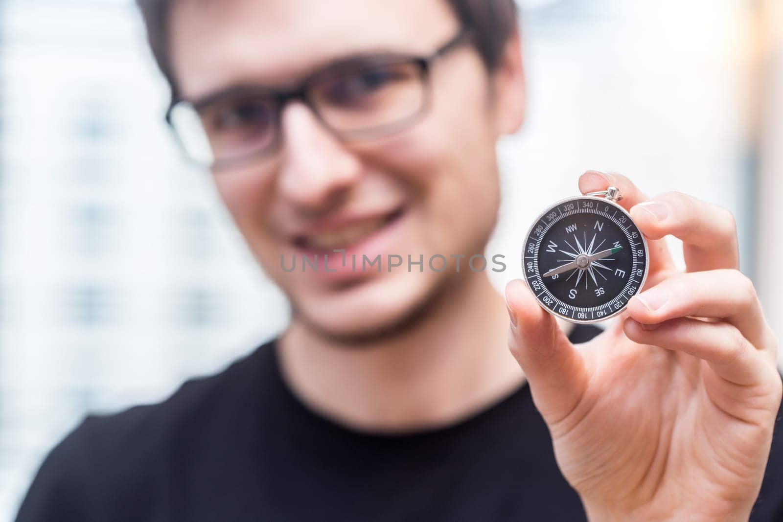 Young freelancer with compass holding in hand