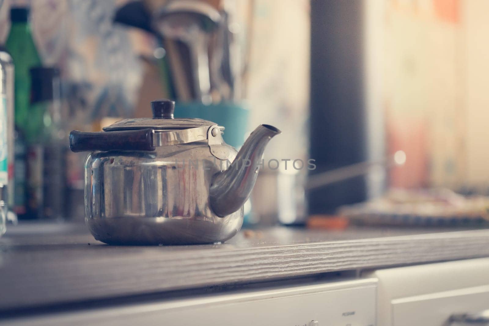 Metal tea cooker on a rustic old oven