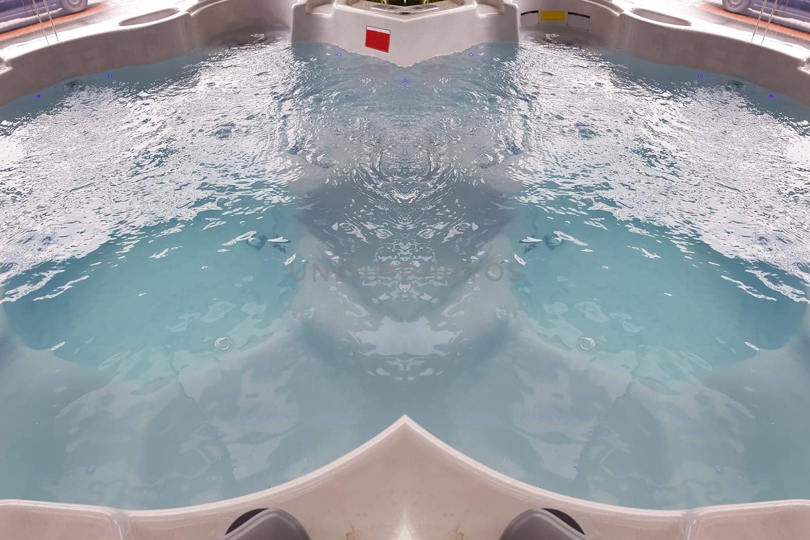 Large spa bath for spa treatments in the salon or inside a house. Empty Jacuzzi Tub Extra Large. Luxurious bathroom with whirlpool with underwater system