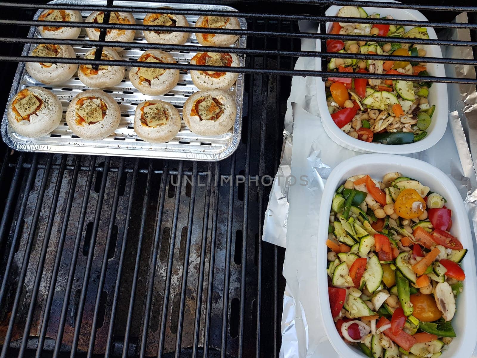 Grilled vegetables on a barbecue grill in a white bowl, top view