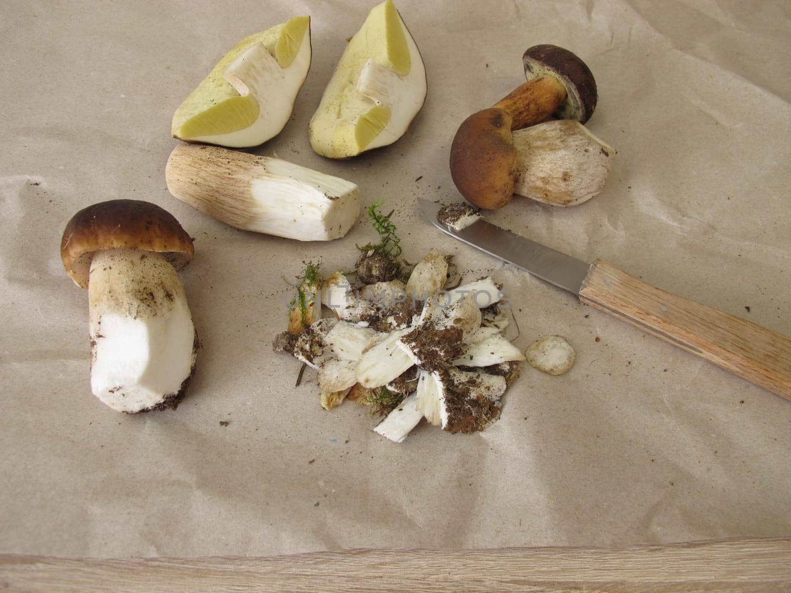 Clean and prepare mushrooms with a knife, porcini and bay bolete
