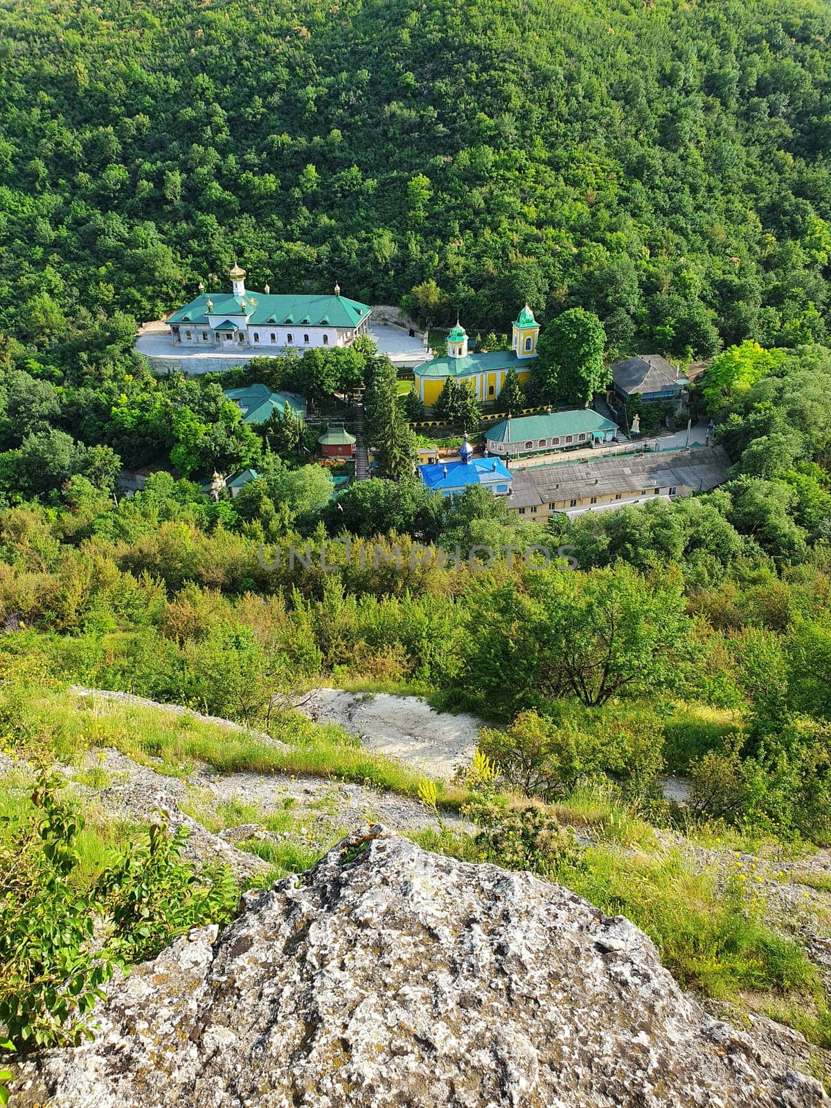 High angle view from altitude to the Saharna Monastery, Moldova. Idyllic place with the church in the middle of woods on the gorge valley
