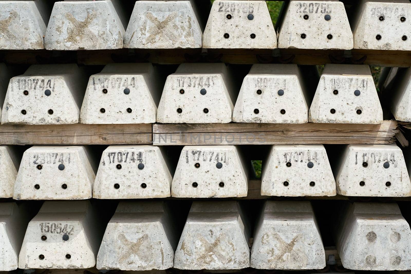 new numbered concrete railroad sleepers at the storage yard of a construction site in Magdeburg in Germany