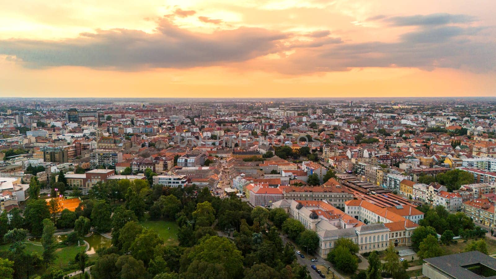 Aerial view of Novi Sad Serbia with sunset sky urban skyline and green park landscape