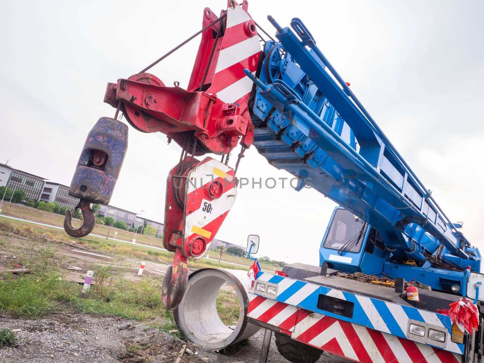 Construction site crane is lifting a led signboard Blank billboard on blue sky background for new advertisement