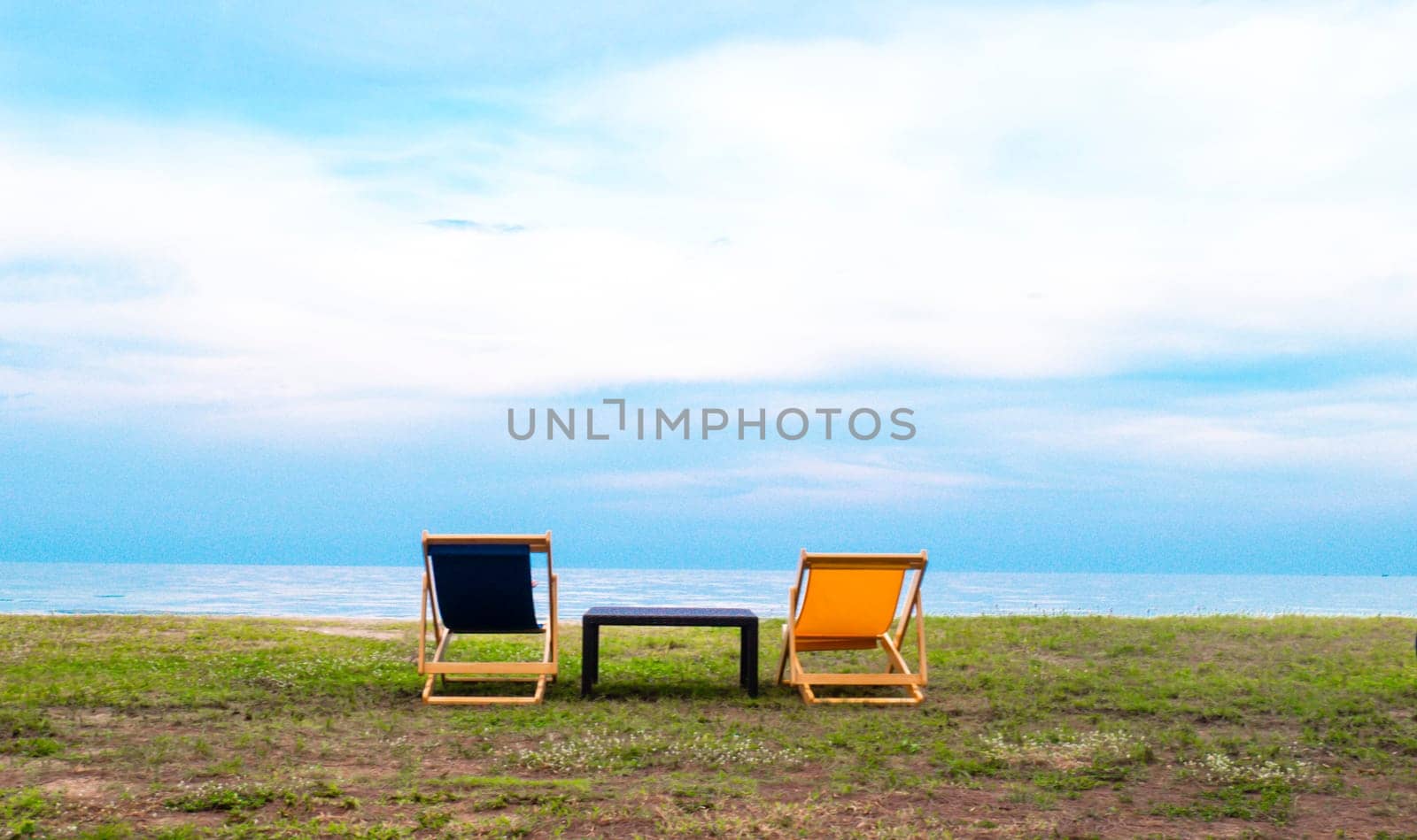 Empty Beautiful color deck chairs on the beach coat with blue sky background. Abstract vacation happy holiday