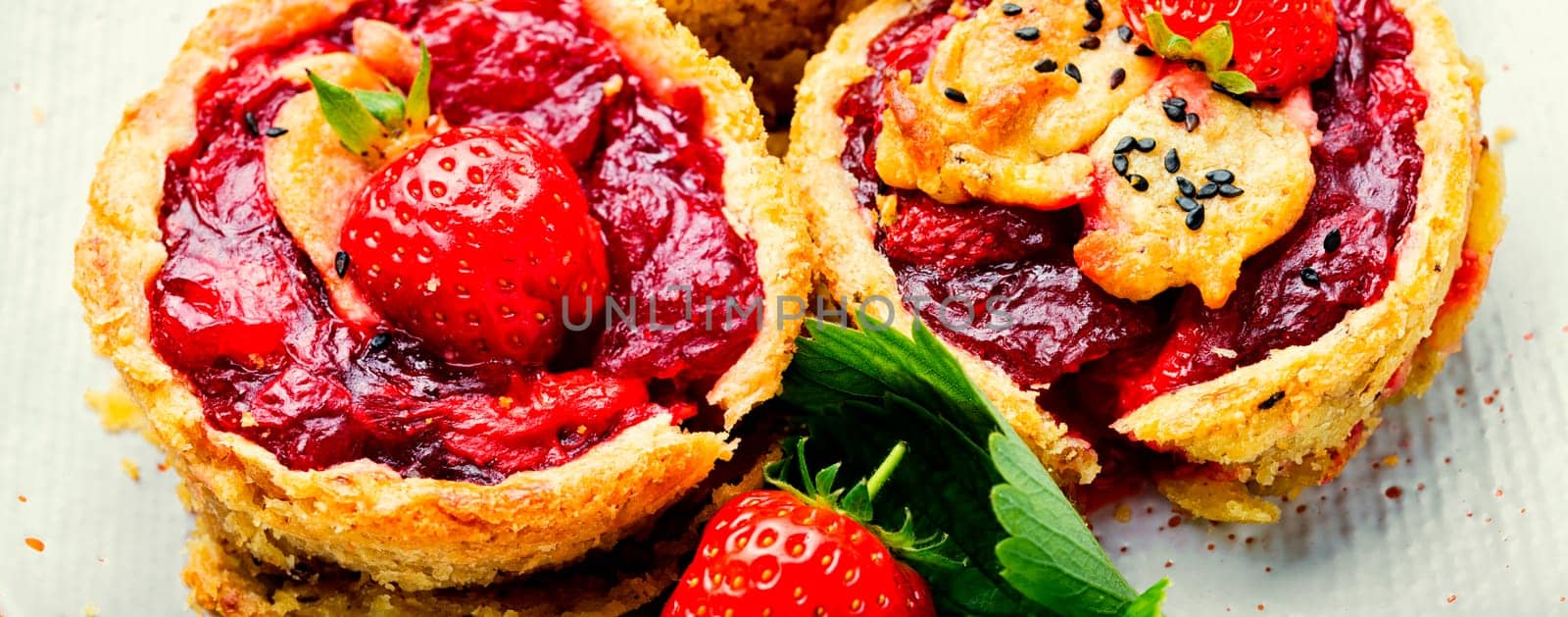 Strawberry shortcake pies.Tasty tartlets with fresh strawberries.Sweet dessert on rustic wooden background
