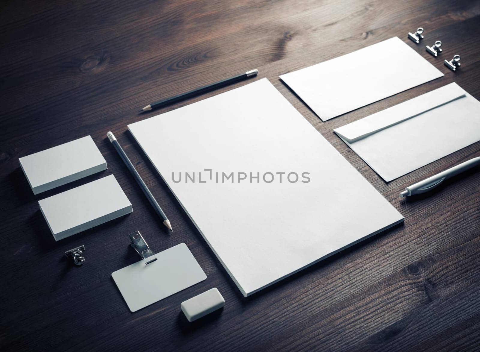 Photo of blank corporate stationery set on wood table background. Branding mock up.