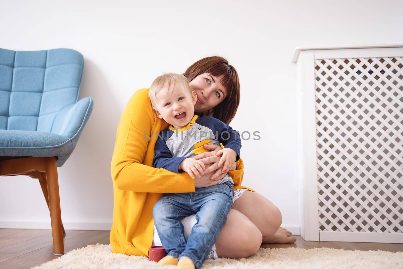 Young mother embracing her cute son carefully. Concept of the family relationship and mother's love.