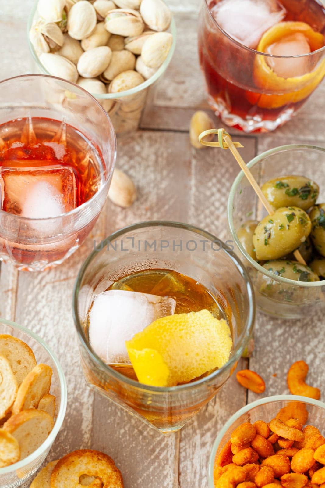 Alcoholic drinks, cocktails on ice and salty snack, appetizers
