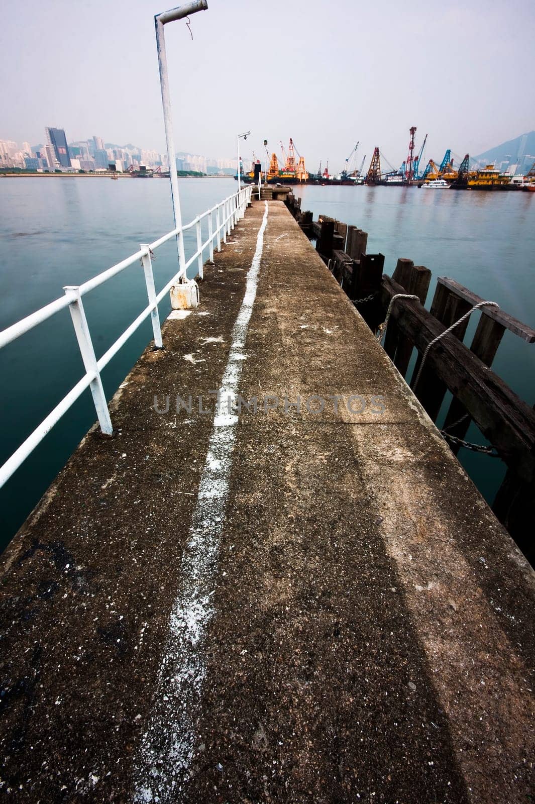 Deserted jetty at a foggy sea near a dutch city. hongkong