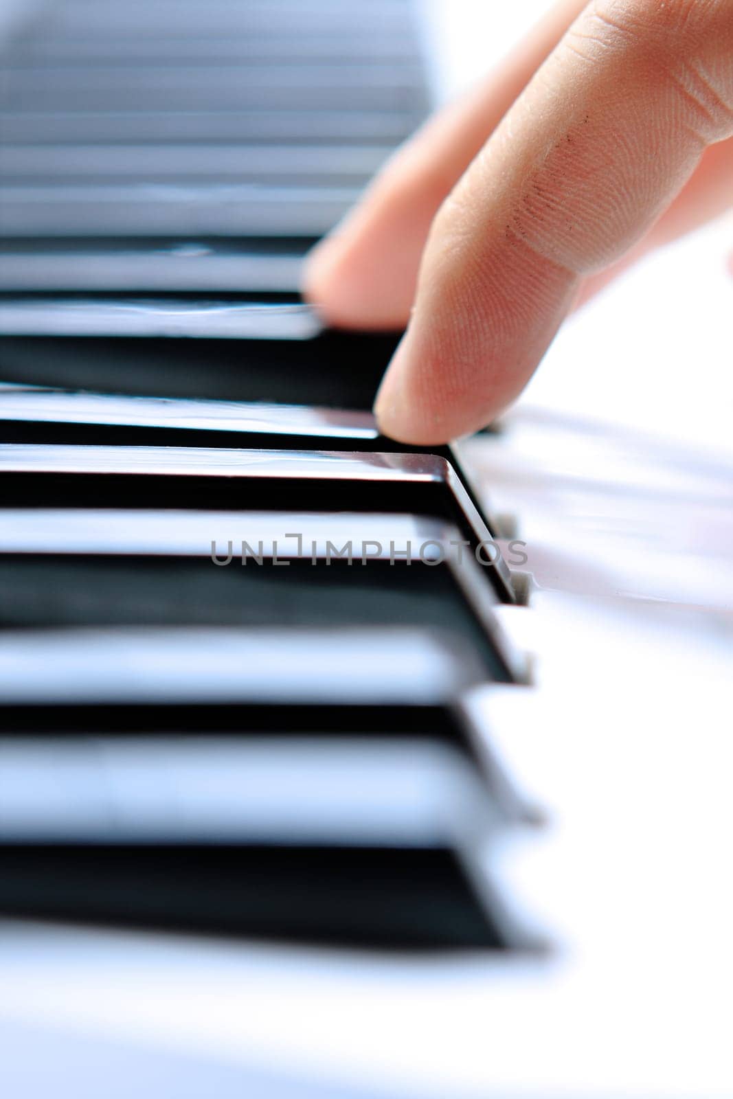 Close up of the hands of a young man playing piano