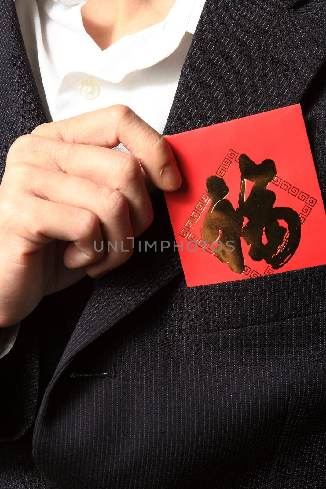 businessman putting chinese cash gift in his pocket