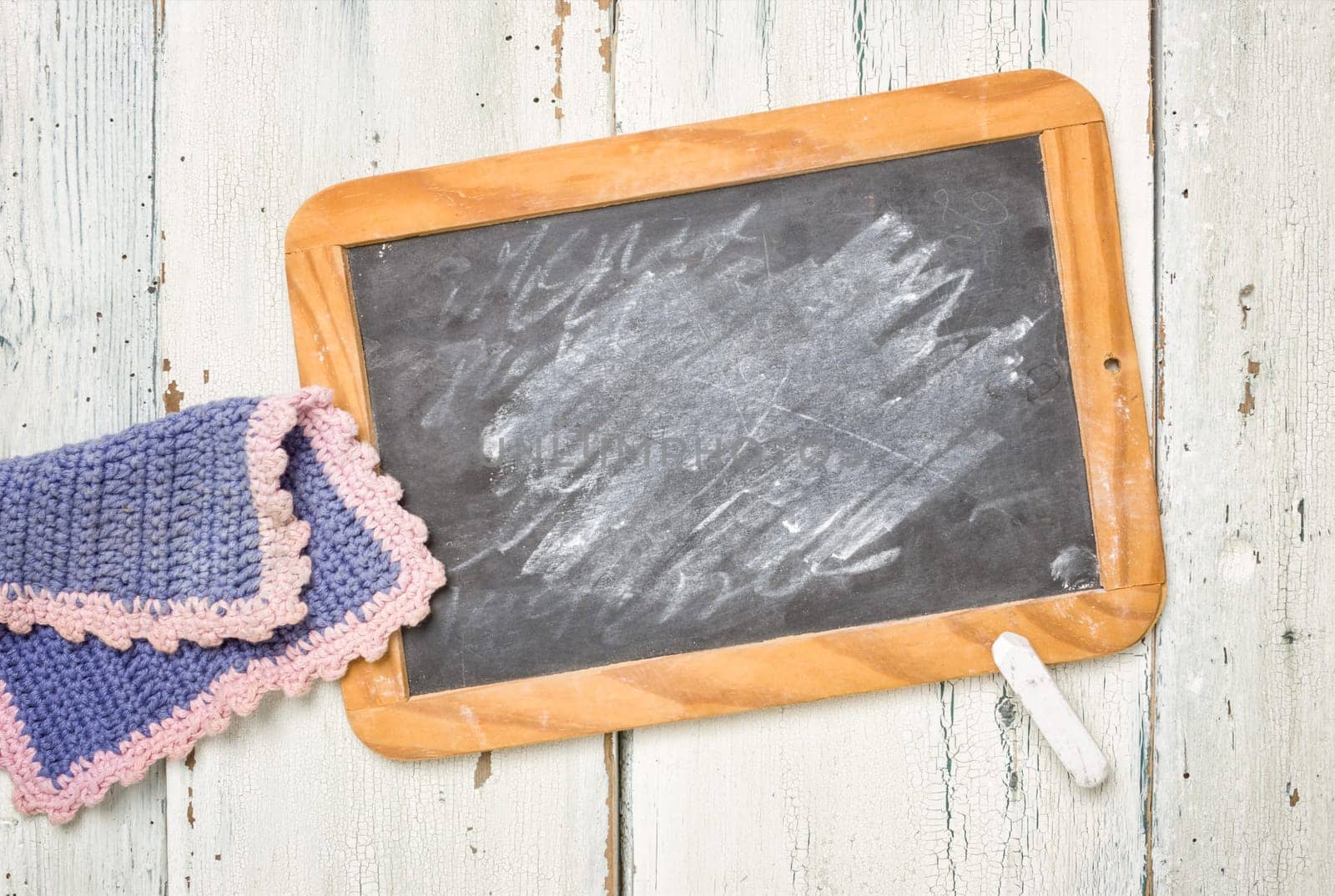 Old blackboard with chalk and cleaning rags