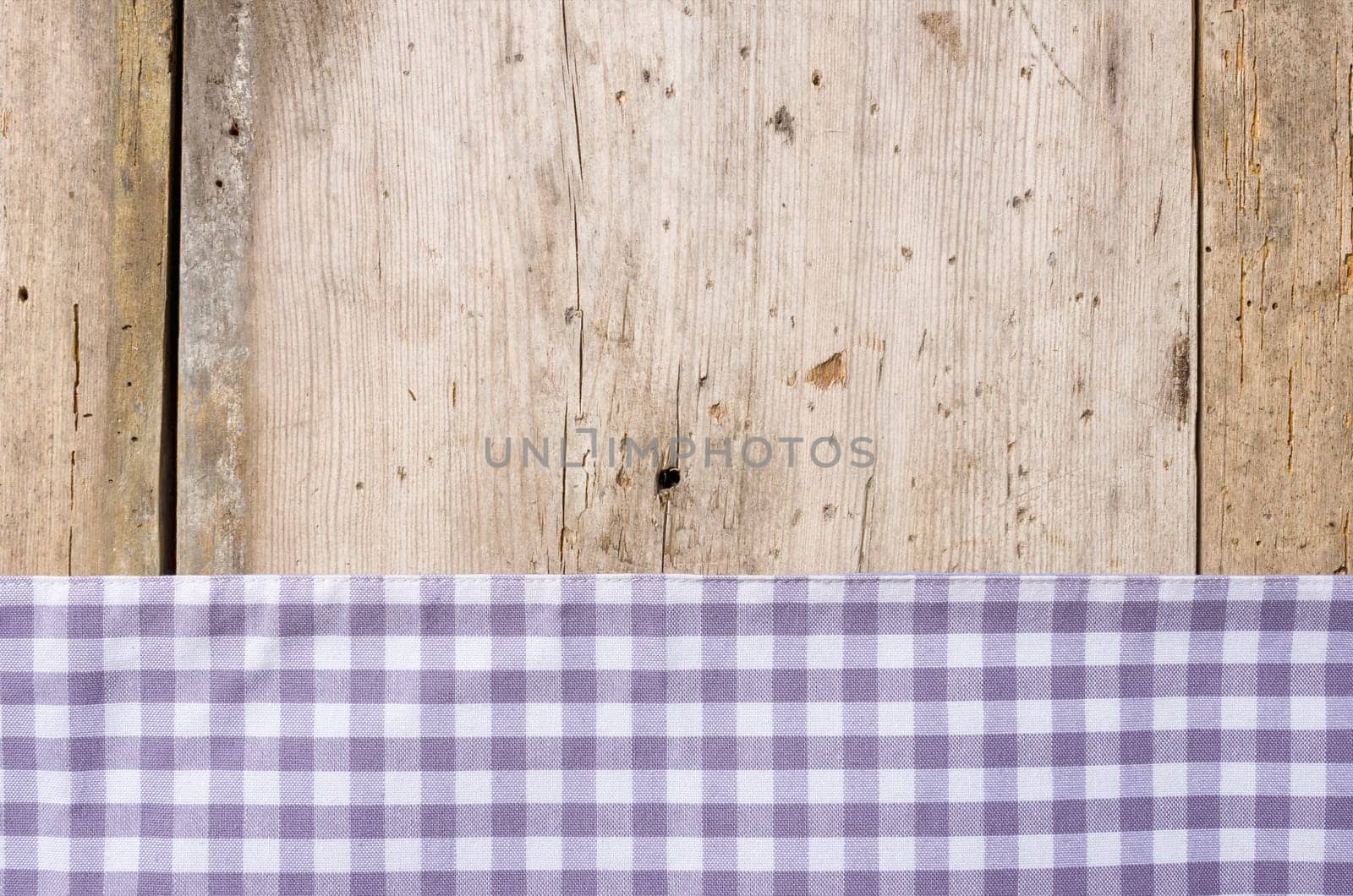 Purple checkered tablecloth against a rustic wooden background