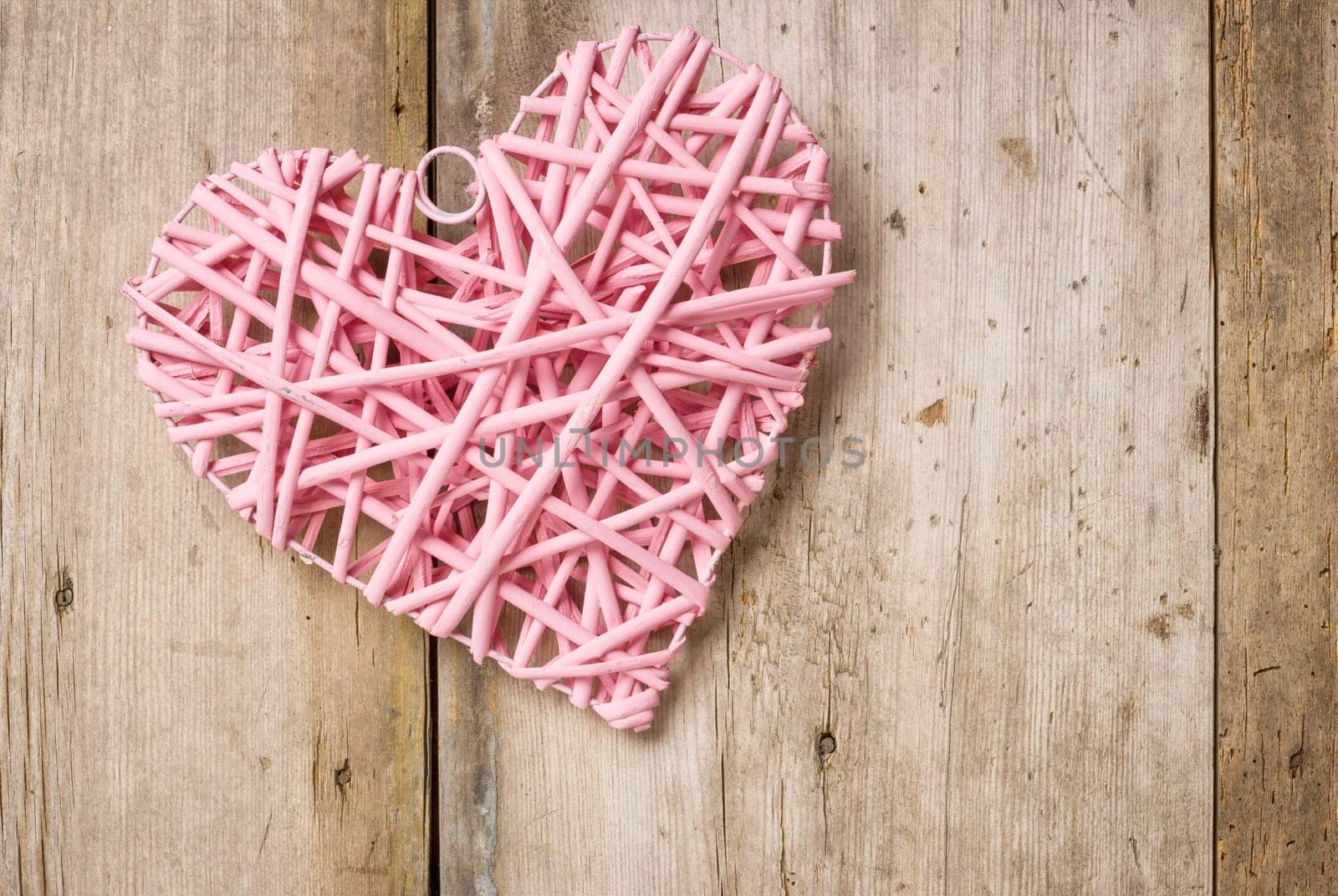 Pink heart in front of rustic wooden boards