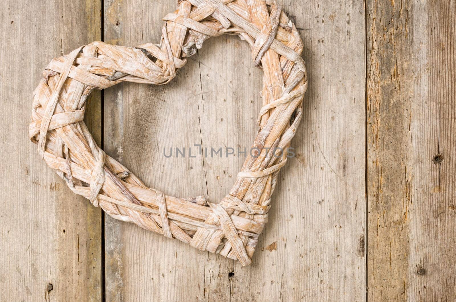 Braided heart in front of rustic wooden boards