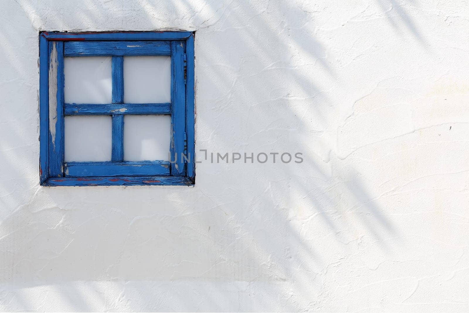 small wooden windows on the white wall