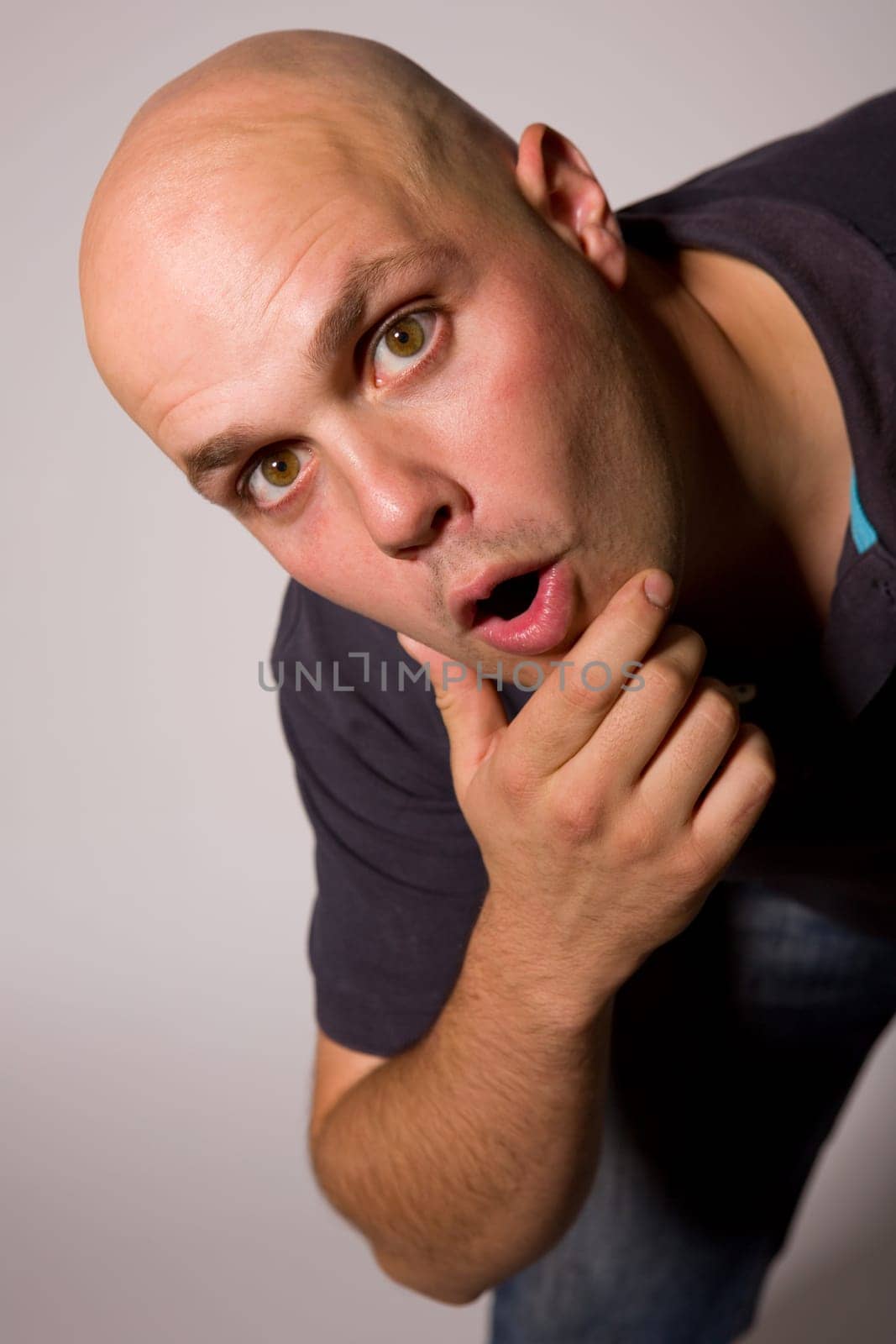 Portrait of young silly man on a dark background