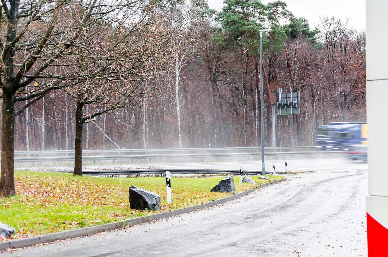 View from a parking lot to a highway in heavy rain.